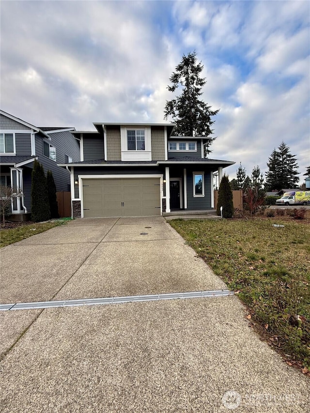 18002 38th Avenue Ct E, Tacoma, WA 98446 - view of front facade featuring driveway, an attached garage, and covered porch