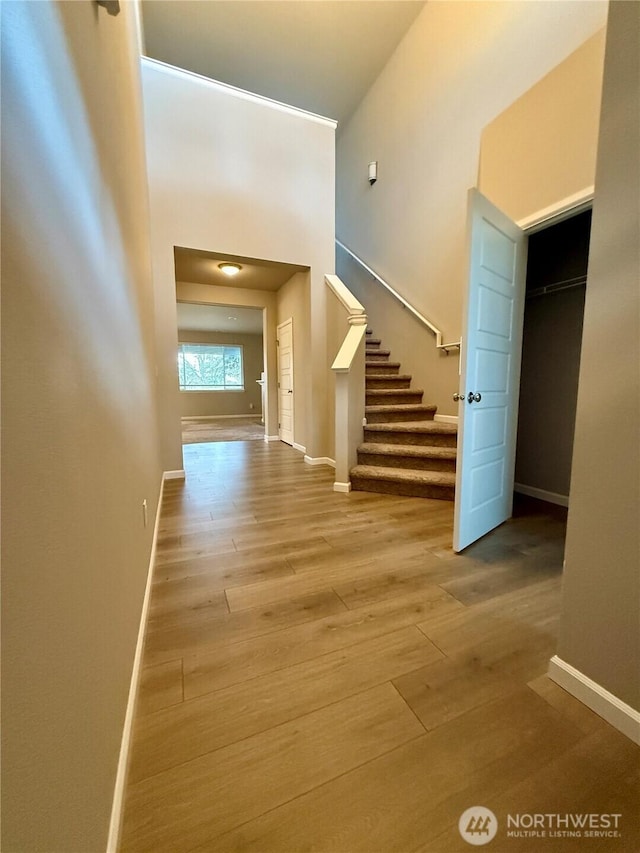18002 38th Avenue Ct E, Tacoma, WA 98446 - staircase featuring wood finished floors, baseboards, and a high ceiling
