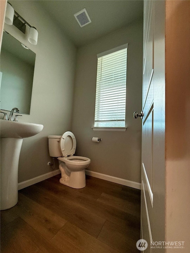 18002 38th Avenue Ct E, Tacoma, WA 98446 - bathroom with toilet, wood finished floors, and baseboards