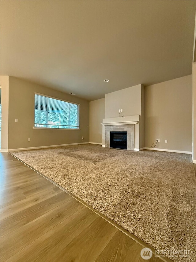 18002 38th Avenue Ct E, Tacoma, WA 98446 - unfurnished living room with wood finished floors, baseboards, and a glass covered fireplace