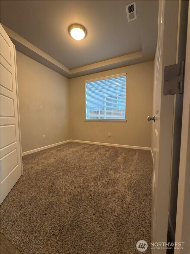 18002 38th Avenue Ct E, Tacoma, WA 98446 - spare room featuring baseboards, a raised ceiling, and carpet