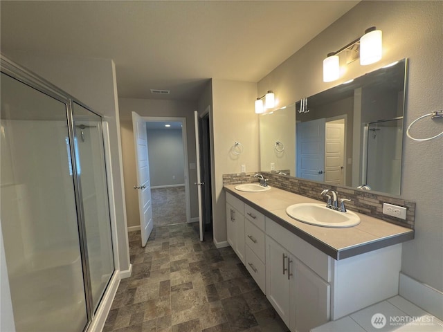 18002 38th Avenue Ct E, Tacoma, WA 98446 - full bathroom featuring a stall shower, baseboards, double vanity, and stone finish floors