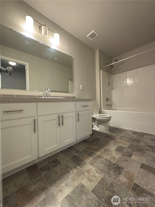 18002 38th Avenue Ct E, Tacoma, WA 98446 - full bath featuring stone tile floors, toilet, tub / shower combination, and vanity