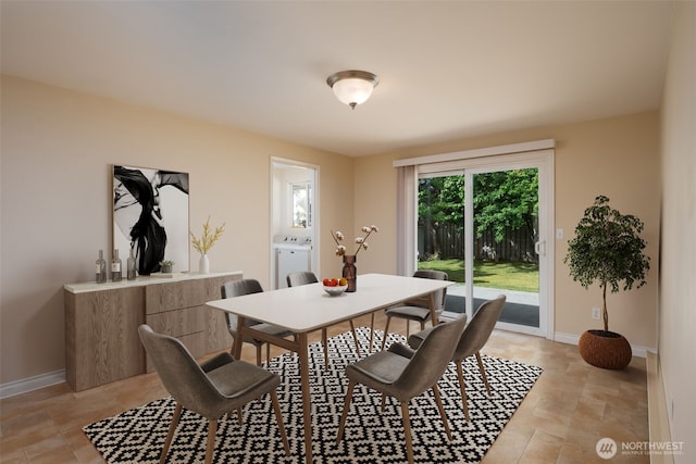 dining area with baseboards, light stone finish floors, and washer and dryer