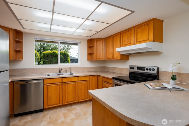 kitchen with stainless steel appliances, open shelves, a sink, under cabinet range hood, and brown cabinets