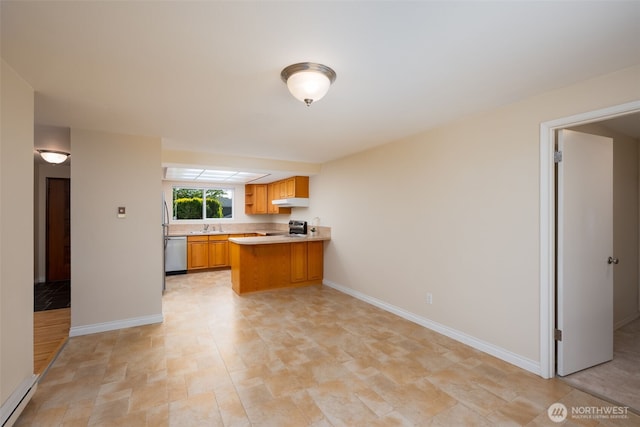 kitchen featuring stainless steel appliances, light countertops, a peninsula, a baseboard heating unit, and under cabinet range hood