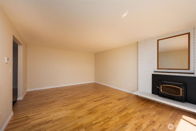 unfurnished living room featuring light wood-style flooring and baseboards
