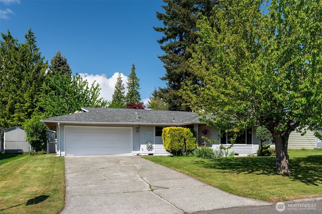 view of front facade with a garage, concrete driveway, and a front yard