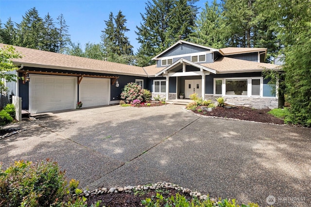 7340 Hawkstone Ave SW, Port Orchard, WA 98367 - view of front of property with a garage, stone siding, driveway, and a shingled roof