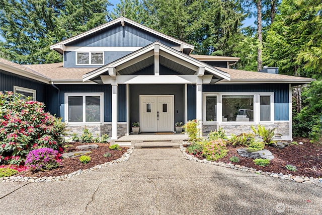 7340 Hawkstone Ave SW, Port Orchard, WA 98367 - craftsman-style home featuring stone siding, a porch, and a shingled roof