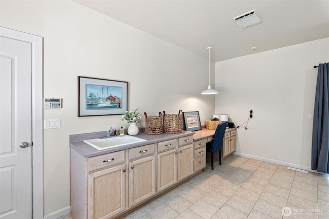 7340 Hawkstone Ave SW, Port Orchard, WA 98367 - bar featuring a sink, baseboards, built in study area, light tile patterned flooring, and decorative light fixtures