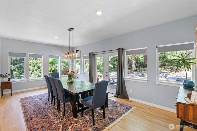7340 Hawkstone Ave SW, Port Orchard, WA 98367 - dining space featuring light wood-style floors, baseboards, french doors, a chandelier, and recessed lighting