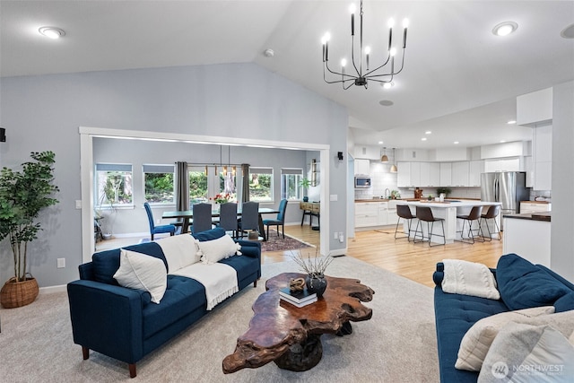 7340 Hawkstone Ave SW, Port Orchard, WA 98367 - living area with a chandelier, light wood finished floors, high vaulted ceiling, recessed lighting, and baseboards