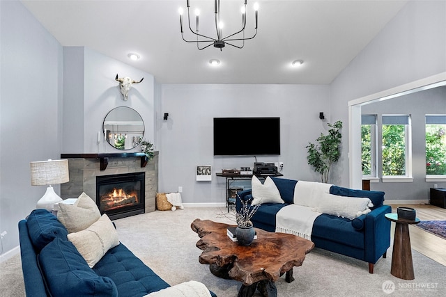 7340 Hawkstone Ave SW, Port Orchard, WA 98367 - carpeted living room featuring a chandelier, baseboards, a glass covered fireplace, and lofted ceiling