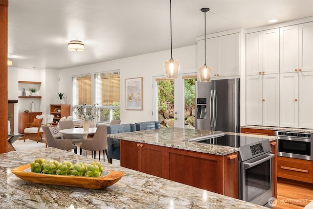 kitchen with stainless steel appliances, light stone counters, white cabinets, decorative light fixtures, and brown cabinets