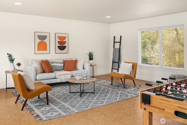 carpeted living area with baseboards and recessed lighting