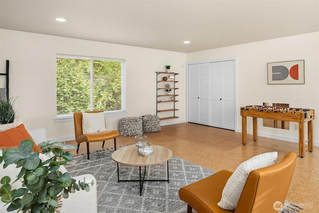 living area featuring tile patterned floors, baseboards, and recessed lighting