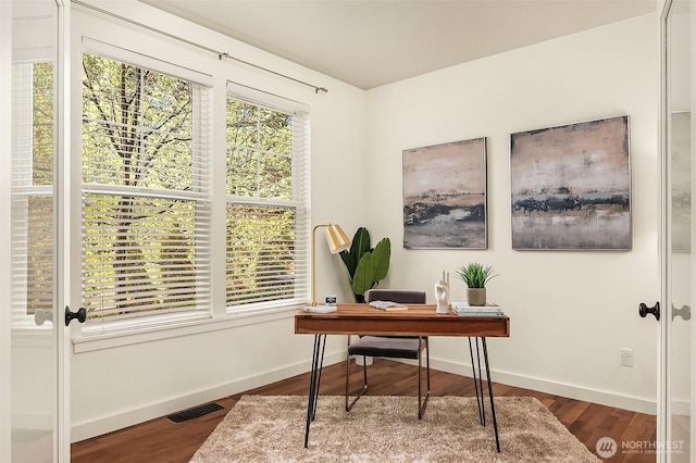 home office with wood finished floors and baseboards