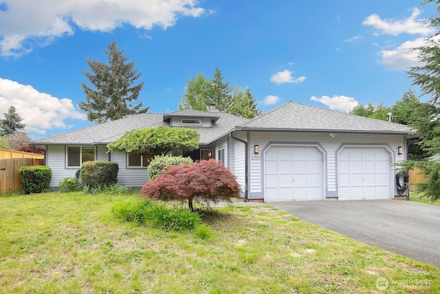 view of front facade featuring an attached garage, driveway, and a shingled roof