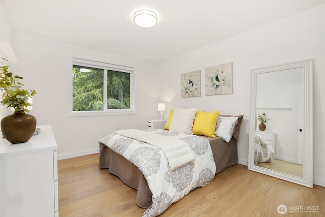 bedroom featuring light wood-style floors and baseboards