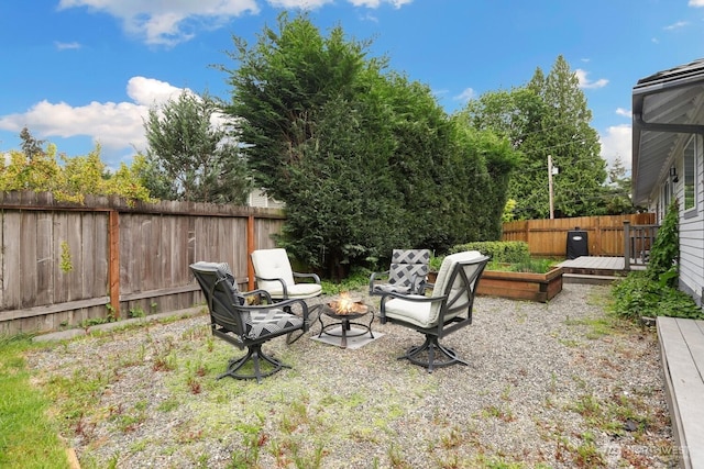 fenced backyard with an outdoor fire pit