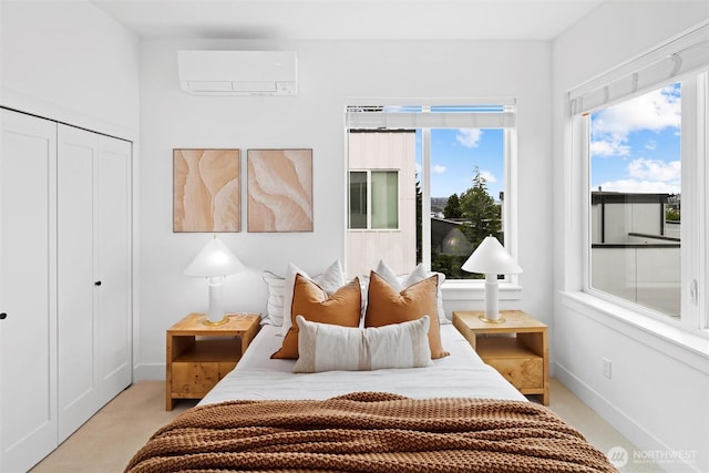 bedroom with a wall unit AC, light carpet, a closet, and baseboards