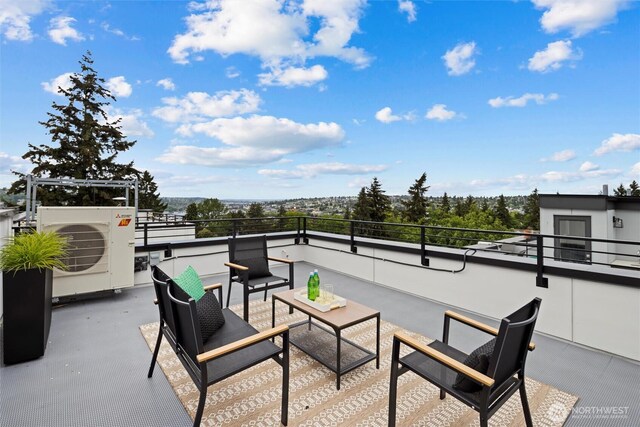 view of patio with a balcony and ac unit