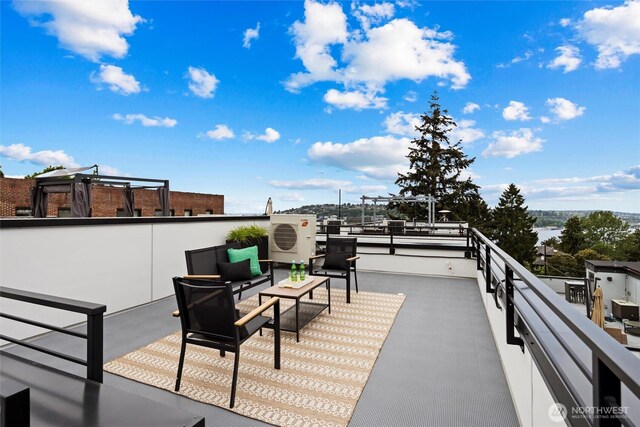 view of patio featuring outdoor lounge area, a cooling unit, and a balcony