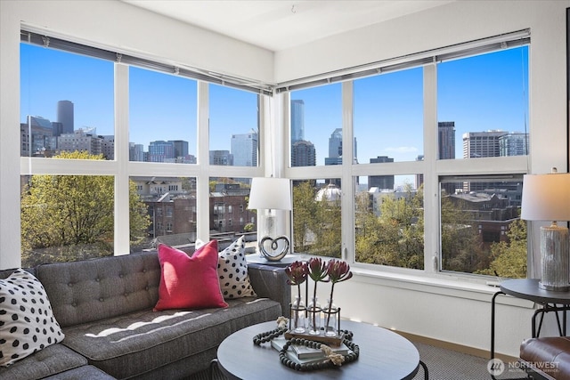 sunroom / solarium featuring a skyline view