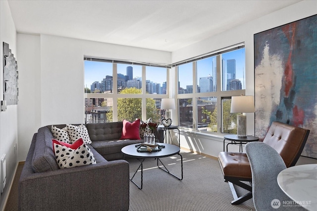 sunroom / solarium featuring a view of skyline and plenty of natural light