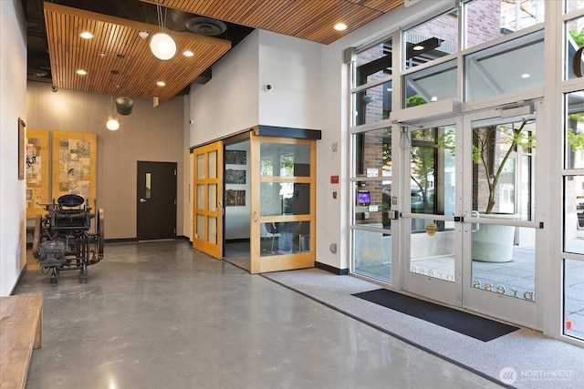common area with a towering ceiling and recessed lighting