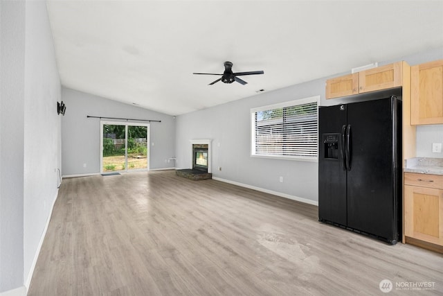 7225 E F St, Tacoma, WA 98404 - unfurnished living room featuring light wood finished floors, a ceiling fan, a fireplace, and vaulted ceiling