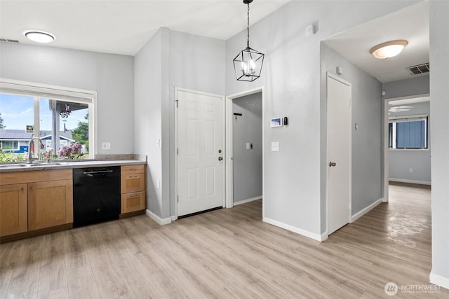 7225 E F St, Tacoma, WA 98404 - kitchen with dishwasher, light wood-type flooring, hanging light fixtures, and brown cabinetry