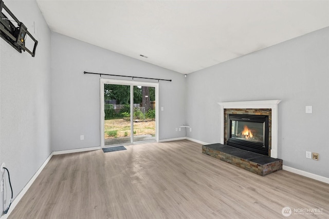 7225 E F St, Tacoma, WA 98404 - unfurnished living room with wood finished floors, a glass covered fireplace, and lofted ceiling