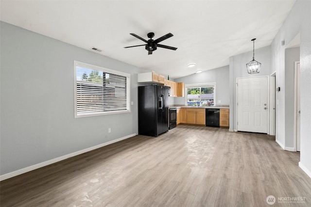 7225 E F St, Tacoma, WA 98404 - kitchen with black appliances, light countertops, light wood-style flooring, vaulted ceiling, and ceiling fan