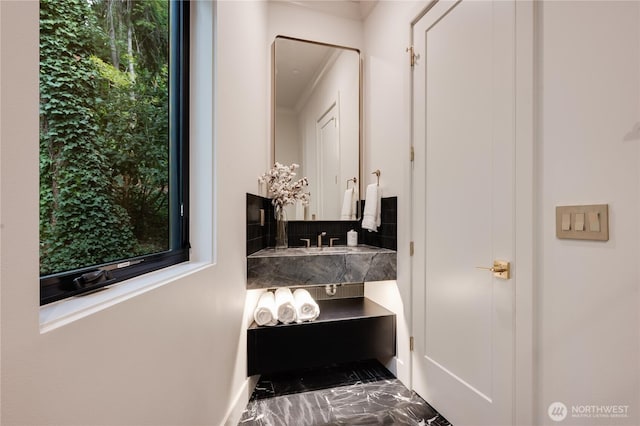 7128 NE 119th Ln, Kirkland, WA 98034 - bathroom with marble finish flooring, decorative backsplash, crown molding, plenty of natural light, and baseboards