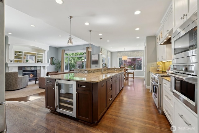 451 245th Ave SE, Sammamish, WA 98074 - kitchen featuring beverage cooler, appliances with stainless steel finishes, dark brown cabinets, dark wood-style floors, and white cabinets