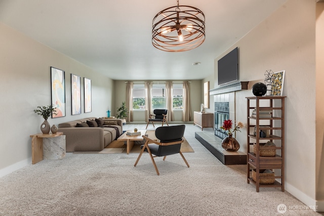 965 W Nickerson St Unit 33, Seattle, WA 98119 - living area with carpet flooring, a tiled fireplace, a chandelier, and baseboards
