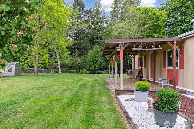17465 NE Noll Rd NE, Poulsbo, WA 98370 - view of yard featuring a wooden deck and an outdoor structure