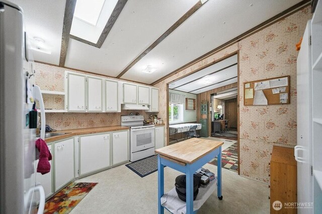 17465 NE Noll Rd NE, Poulsbo, WA 98370 - kitchen featuring white appliances, wallpapered walls, white cabinetry, under cabinet range hood, and light countertops