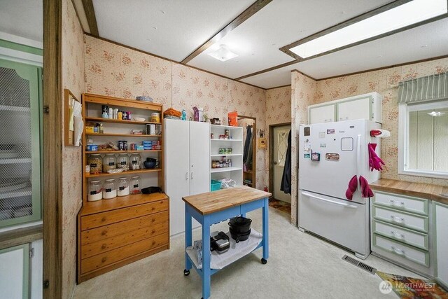 17465 NE Noll Rd NE, Poulsbo, WA 98370 - kitchen featuring freestanding refrigerator, wallpapered walls, and open shelves