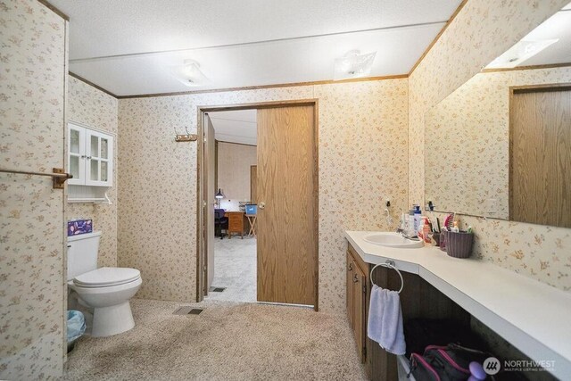 17465 NE Noll Rd NE, Poulsbo, WA 98370 - bathroom featuring vanity, toilet, and wallpapered walls