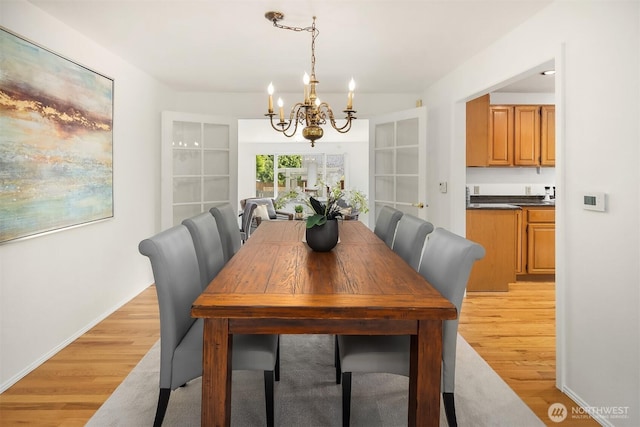 dining room featuring a chandelier and light wood-style floors