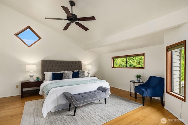 bedroom with wood finished floors, ceiling fan, baseboards, and lofted ceiling