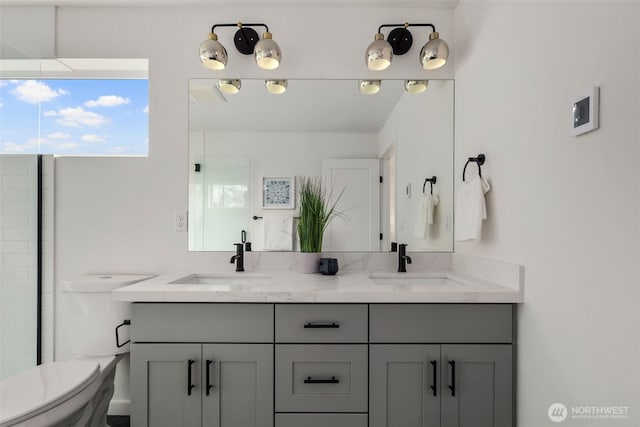 bathroom featuring toilet, double vanity, and a shower