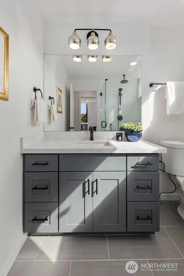 full bath with vanity, toilet, and tile patterned floors