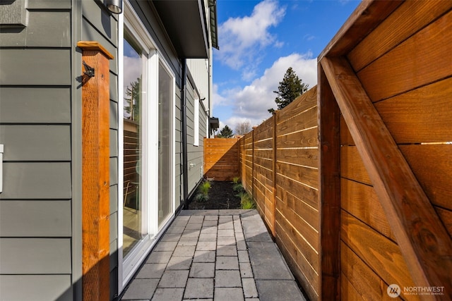 view of home's exterior with fence and a patio area
