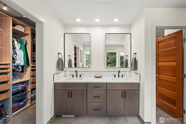 471 Dungeness Dr, Fox Island, WA 98333 - full bath with tile patterned flooring, double vanity, a walk in closet, and recessed lighting