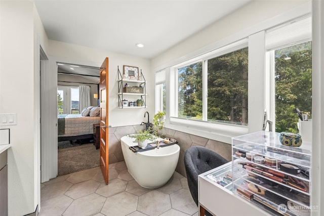 471 Dungeness Dr, Fox Island, WA 98333 - ensuite bathroom with a freestanding tub, tile patterned floors, recessed lighting, and tile walls