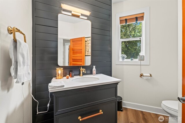 471 Dungeness Dr, Fox Island, WA 98333 - bathroom with wood finished floors, baseboards, vanity, and toilet